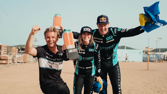 Nico Rosberg celebrates with the drivers of his Extreme E series team.